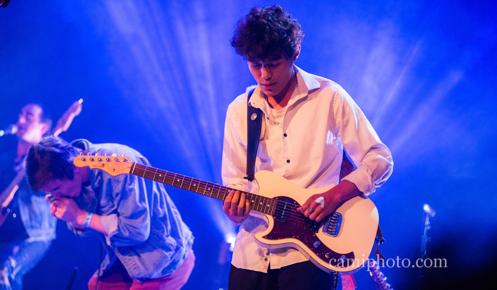 Dylan Miles playing guitar on stage